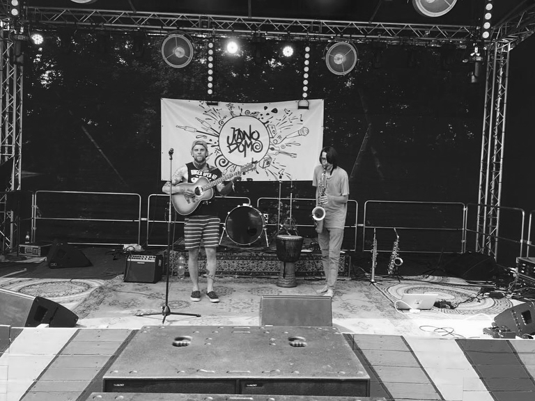 Jano Domo performing on Stage with Hans From Space Stage Banner artwork in background, Ackerkult 2018